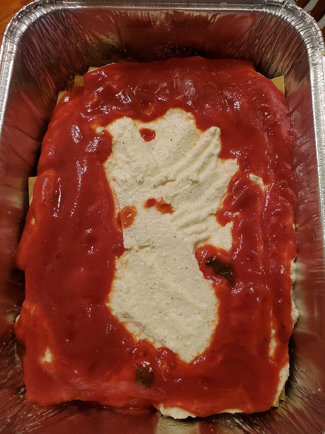 homemade lasagna noodles with ricotta layered and sauce