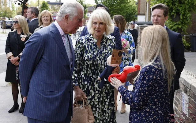 The Duchess of Cornwall wore a floral print silk dress by designer, Fiona Clare. Camilla carried for her Bottega Veneta bag