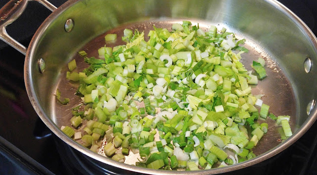Saute celery, celery leaves and green onions in bacon grease drippings