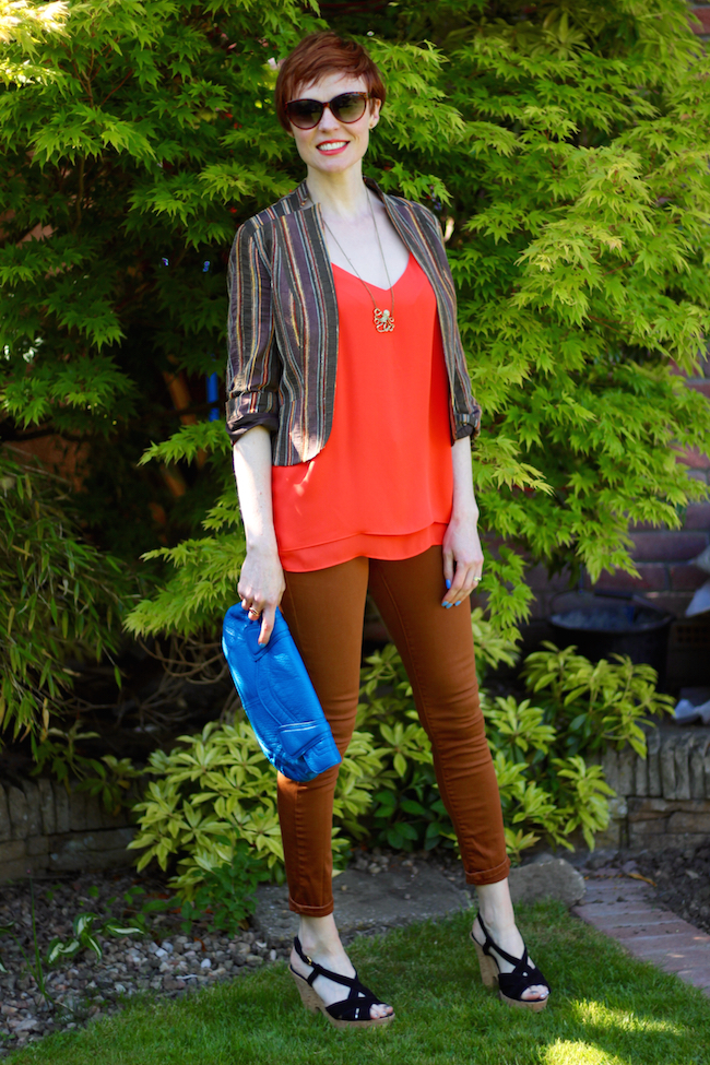 Fake Fabulous | Bright orange top, cropped brown jacket, bright blue clutch and octopus necklace.