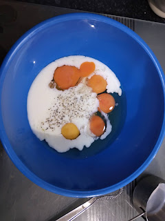 Eggs milk and seasoning in a bowl