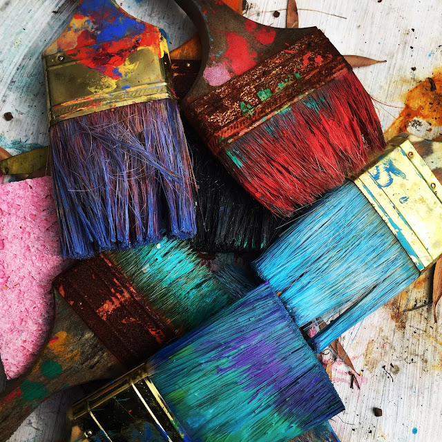 paint brushes covered in multi coloured paint:Photo by RhondaK Native Florida Folk Artist
