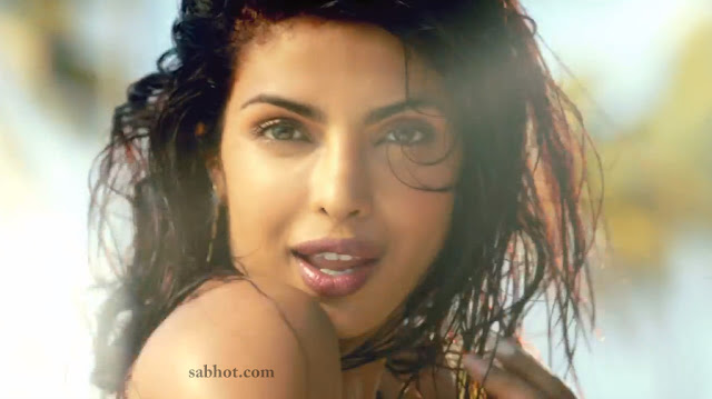 Priyanka Chopra in a sexy golden bikini stills from Exotic feat Pitbull