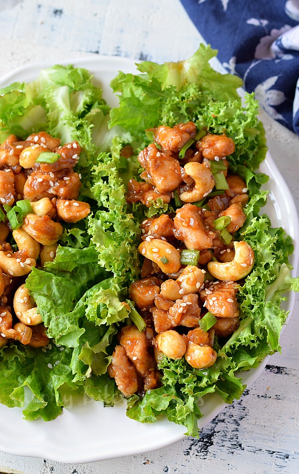 delicious cashew chicken lettuce wraps served on a white plate