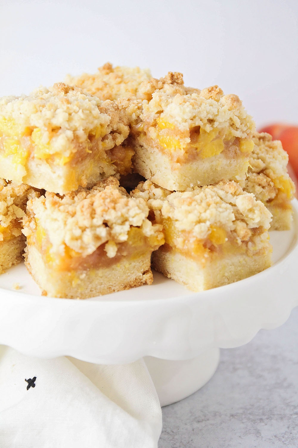 These delicious peach crumb bars have a sweet and buttery crumb mixture, surrounding juicy and tender peaches. They're perfect for summer!