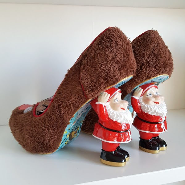 Santa heeled shoes sitting on shelf with brown fur uppers