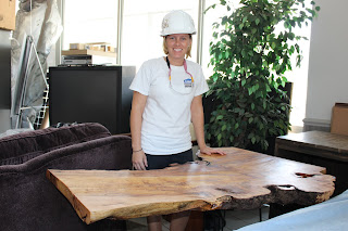 Stacy displays the wooden table she worked hard to complete!