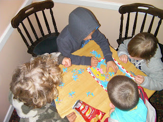 children completing a map of the world jigsaw