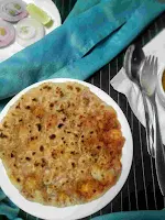 Serving amritsari kulcha, onion slices in background