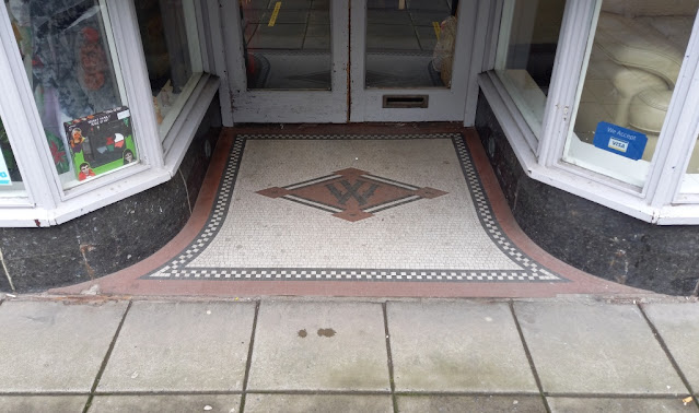 The mosaic tile logo at the old Woolworths on Stamford Street Central in Ashton-under-Lyne, Tameside, Greater Manchester