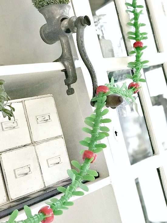 garland hanging from vintage meat grinder