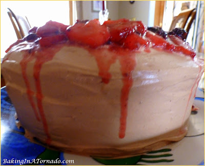 Angel Cake with Chocolate Whipped Cream and Berries, heavenly flavors marry in a light and fluffy cake layered with chocolate whipped cream and mascerated berries. | Recipe developed by www.BakingInATornado.com | #recipe #cake #dessert