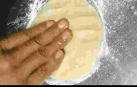 Flattering dough ball with finger tips for tandoori roti recipe