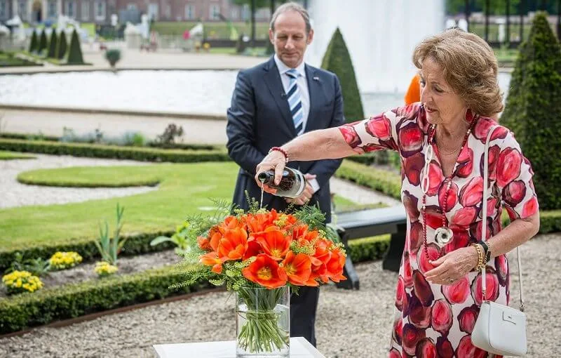 Princess Margriet wore a red floral print dress and red pumps, red earrings, carried white bag