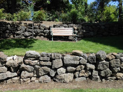 park bench, rock wall, park,