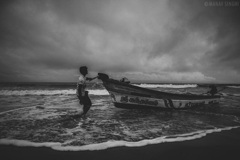 A Fisherman trying to control his boat at Fisherman Area near Le Pondy Beach Resort, Pondicherry- 30-Oct-2019 A Fisherman trying to control his boat at Fisherman Area near Le Pondy Beach Resort, Pondicherry- 30-Oct-2019