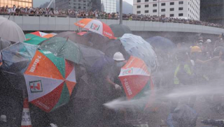 Hong Kong police use tear gas against protesters attempting to storm parliament Hong Kong police use tear gas against protesters attempting to storm parliament