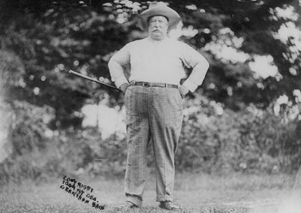 President William Howard Taft holding golf club