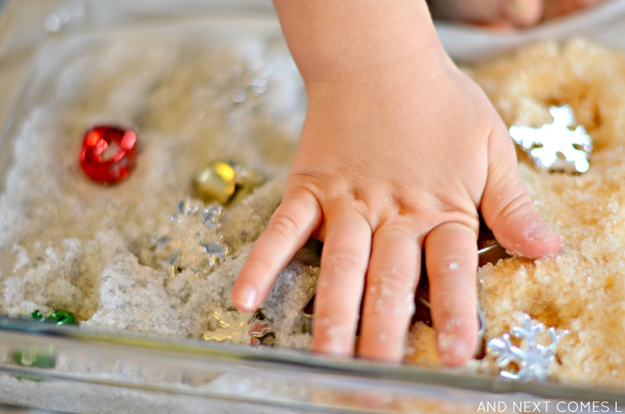 Playing with gold & silver epsom salts in a Christmas sensory bin from And Next Comes L
