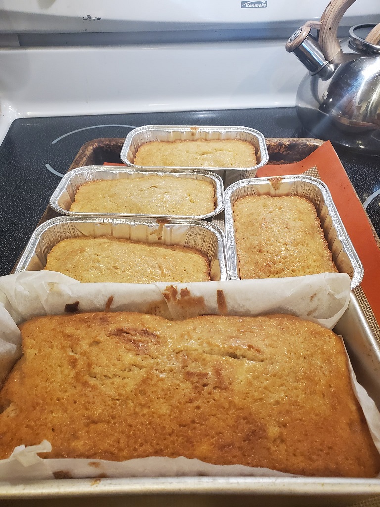 these are banana zucchini breads cooling there are 4 miniatures and 1 large loaf