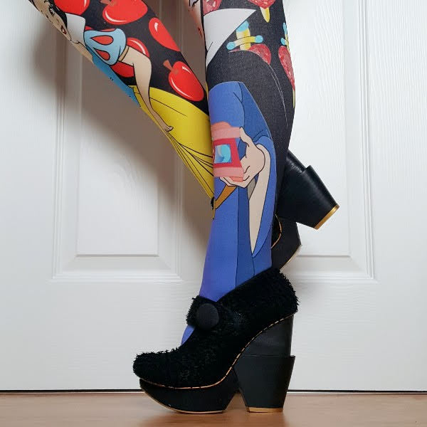 wearing bright patterned tights and textured black wooden heel shoes