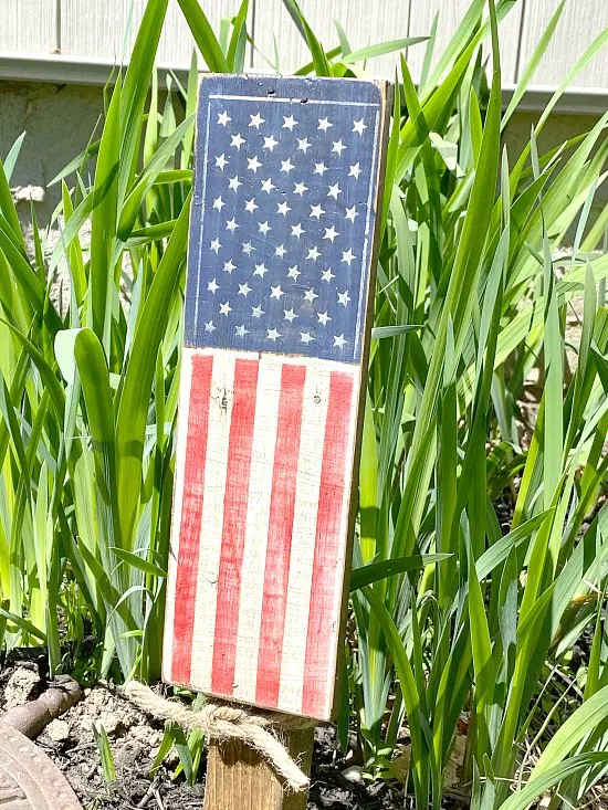 American flag stenciled plant stake in the garden