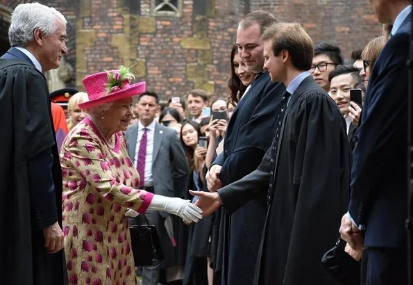 Queen Elizabeth wore a floral satin dress, pink coat and pink hat for visit National Institute of Agricultural Botany