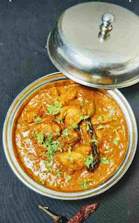 Serving kadai chicken in a serving bowl with a lid