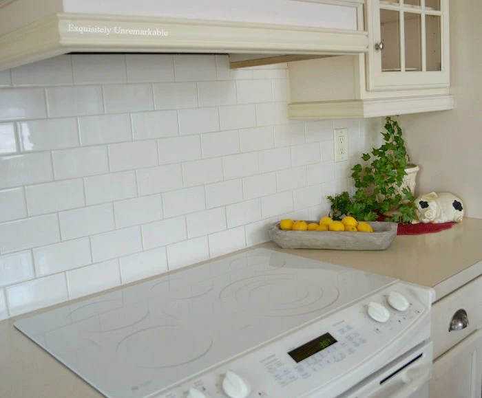 White glass electric stove in a white kitchen