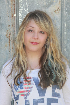 portrait of woman standing in front of metal siding