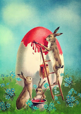 Bunnies painting in red a big egg