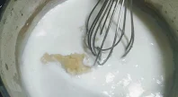 Roux mixing with hot milk for white sauce pasta recipe
