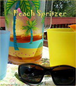 Peach Spritzer, a fruity summer version of a wine spritzer. A cool refreshing drink for a hot summer night. | Recipe developed by www.BakingInATornado.com | #recipe #cocktail