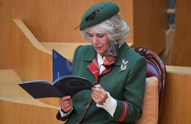 The Queen selected Queen Mary's Diamond Thistle Brooch for her lapel. Prince of Wales and Duchess of Cornwall