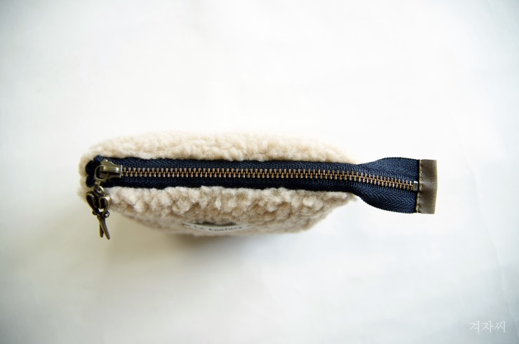 Small cosmetic pouch made of faux fur makeup bag mini wallet. Small cosmetic pouch made of faux fur makeup bag mini wallet.