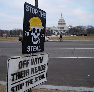 Signs: "Stop the 2020 Steal", "Off With Their Heads"; US Capitol in background