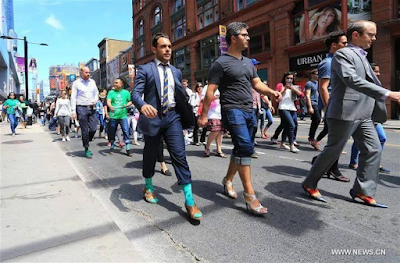 Men wear high-heel shoes in a campaign to end violence against women ...