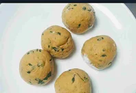 Making round shaped dough balls for Methi paratha recipe
