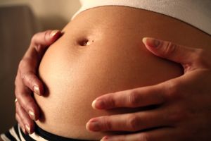 Image: Belly 2: Belly of a pregnant woman in evening light, by Chris Greene(christgr) on FreeImages