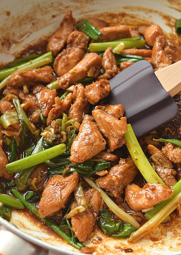 easy mongolian chicken with amazing sauce in a pan with scallion