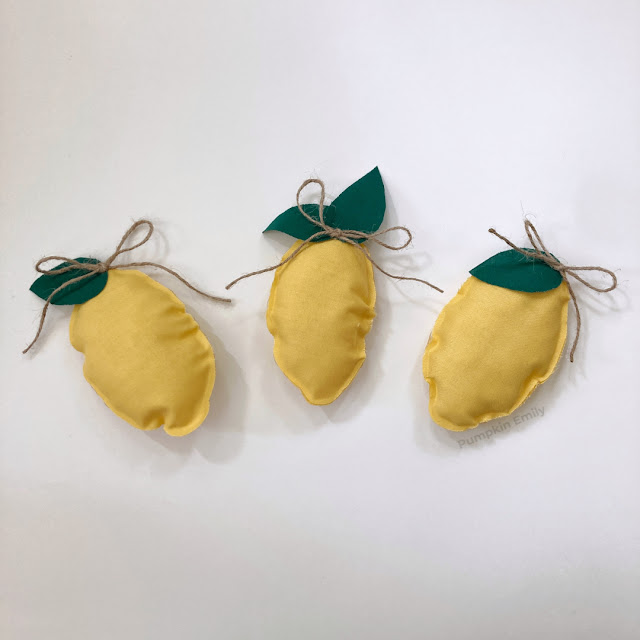 Three lemons made out of fabric.