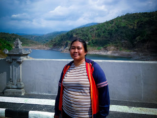 Woman Traveler Enjoy A Holiday Above The Large Titab Ularan Dam In The Sunny Cloudy Day Of Dry Season North Bali Indonesia