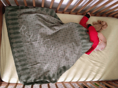Grand baby beneath his Wee Coverlet
