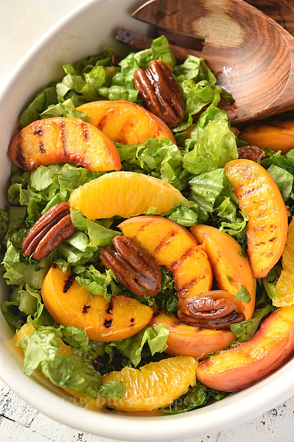 a close look of a white bowl with grilled peach salad