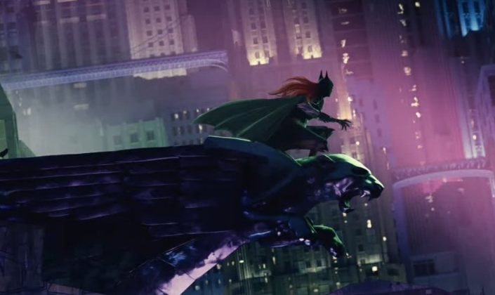 Imagem de capa: arte conceitual da Batgirl, uma garota ruiva em um uniforme preto com máscara de morcego, capa e luvas amarelas em cima de uma gágula em formato de leão com um par asas em um prédio de Gotham com torre de relógio e inúmeros arranha-céus na frente.