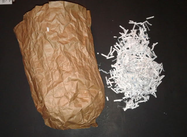 Directions to make a simple Halloween or autumn pumpkin decoration out of a brown lunch bag, shredded paper, glitter and paint.  Toddler friendly.