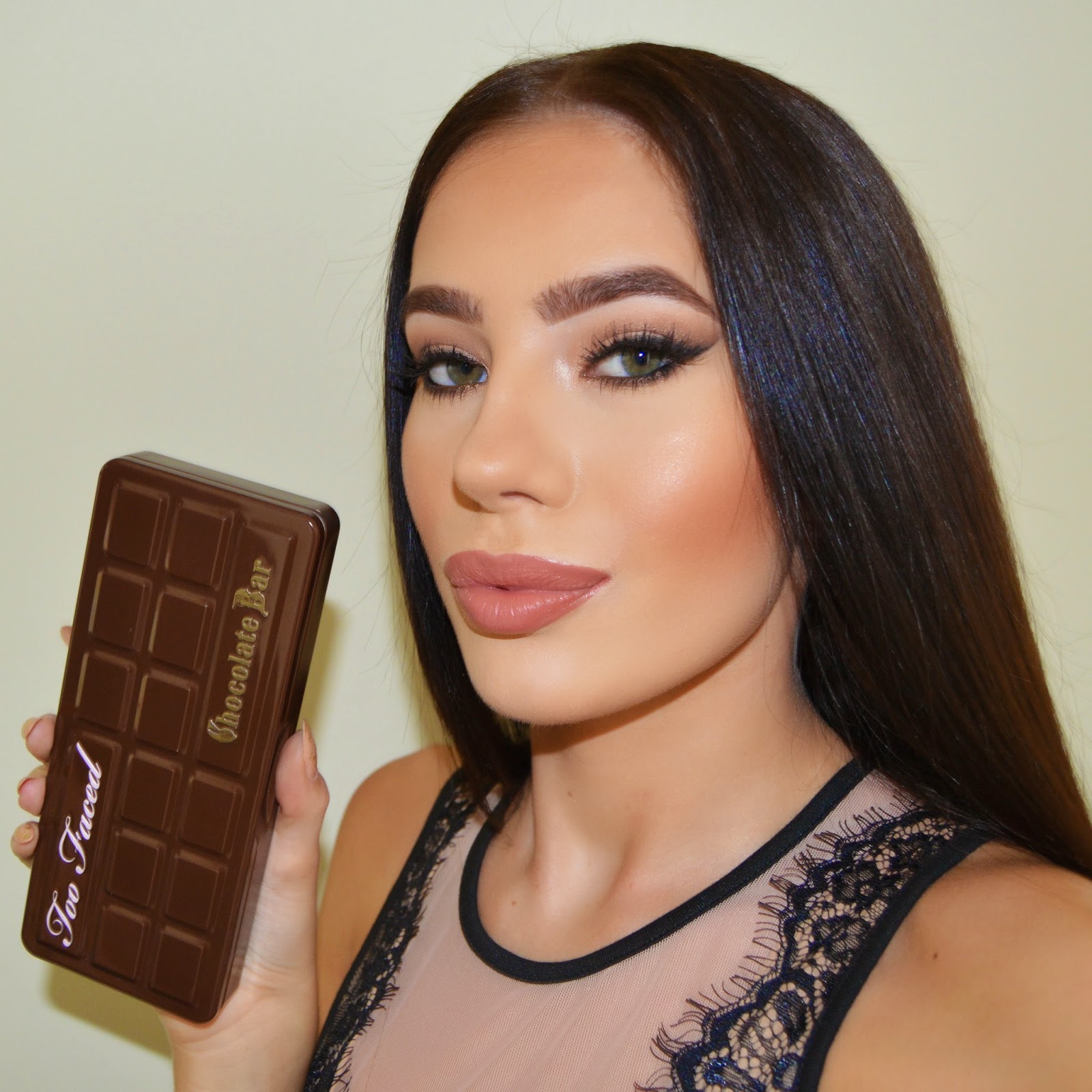 A person wearing makeup using the Too Faced Chocolate Bar Pallete