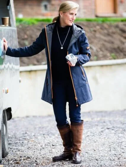 The Countess is patron of the Association of Show and Agricultural Organisations. navy coat and boots. The Countess visited DEBRA store