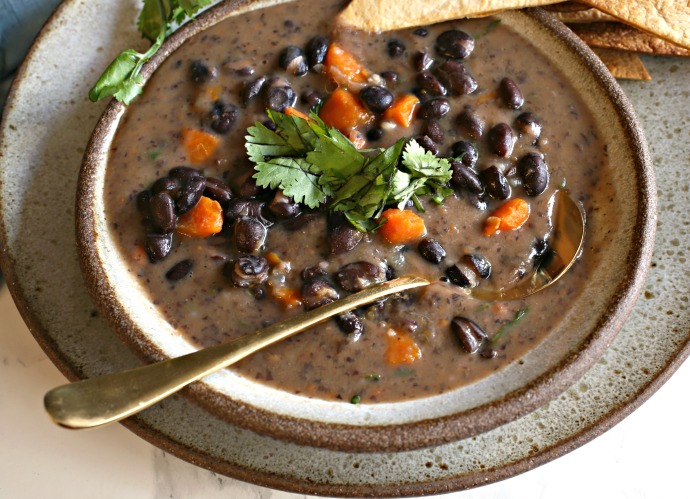 Recipe for soup made with onions, carrots, black beans, cumin and chicken stock.