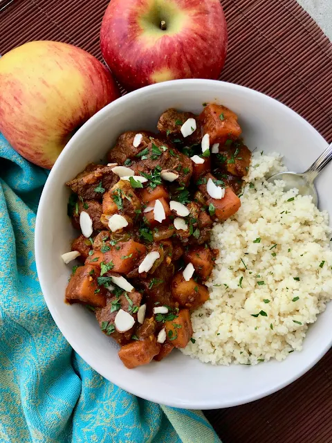 Bowl of Moroccan apple and sweet potato beef stew with couscous.